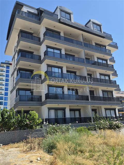 For sale in Mahmutlar: 1+1 furnished | 2 years old, 3rd floor, south-facing, 500m from the sea, with a hammam