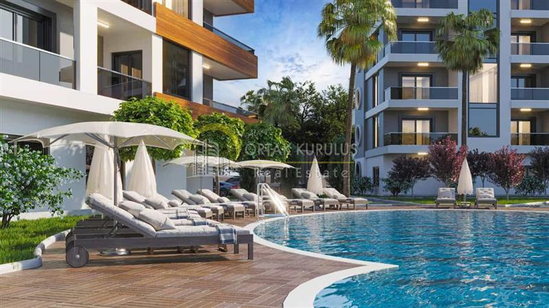 Located on Ataturk Avenue in Mahmutlar, for sale is a fully equipped 2+1 apartment in the New Upper Project, along with a full-service complex.