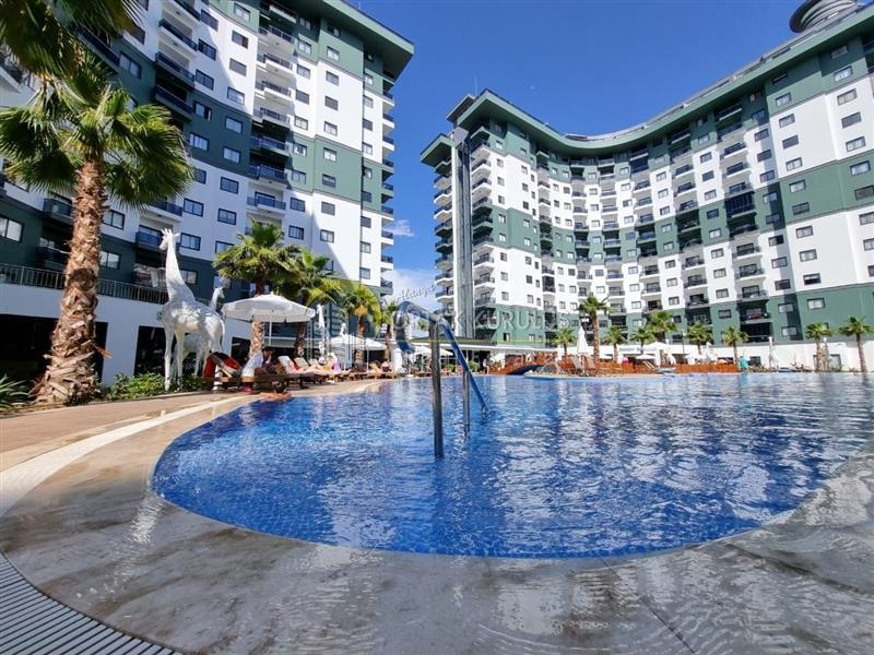 1+1 furnished apartment with sea view for sale in Mahmutlar, Alanya.