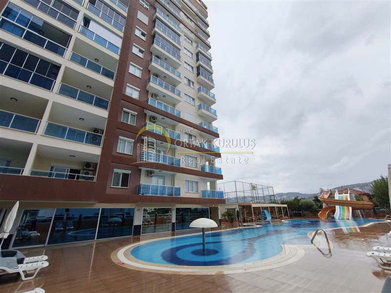 Mahmutlar Dörtyol Satılık 1+1 | 65m² Batı Cepheli Aquaparklı Kapalı Otoparklı Eşyalı